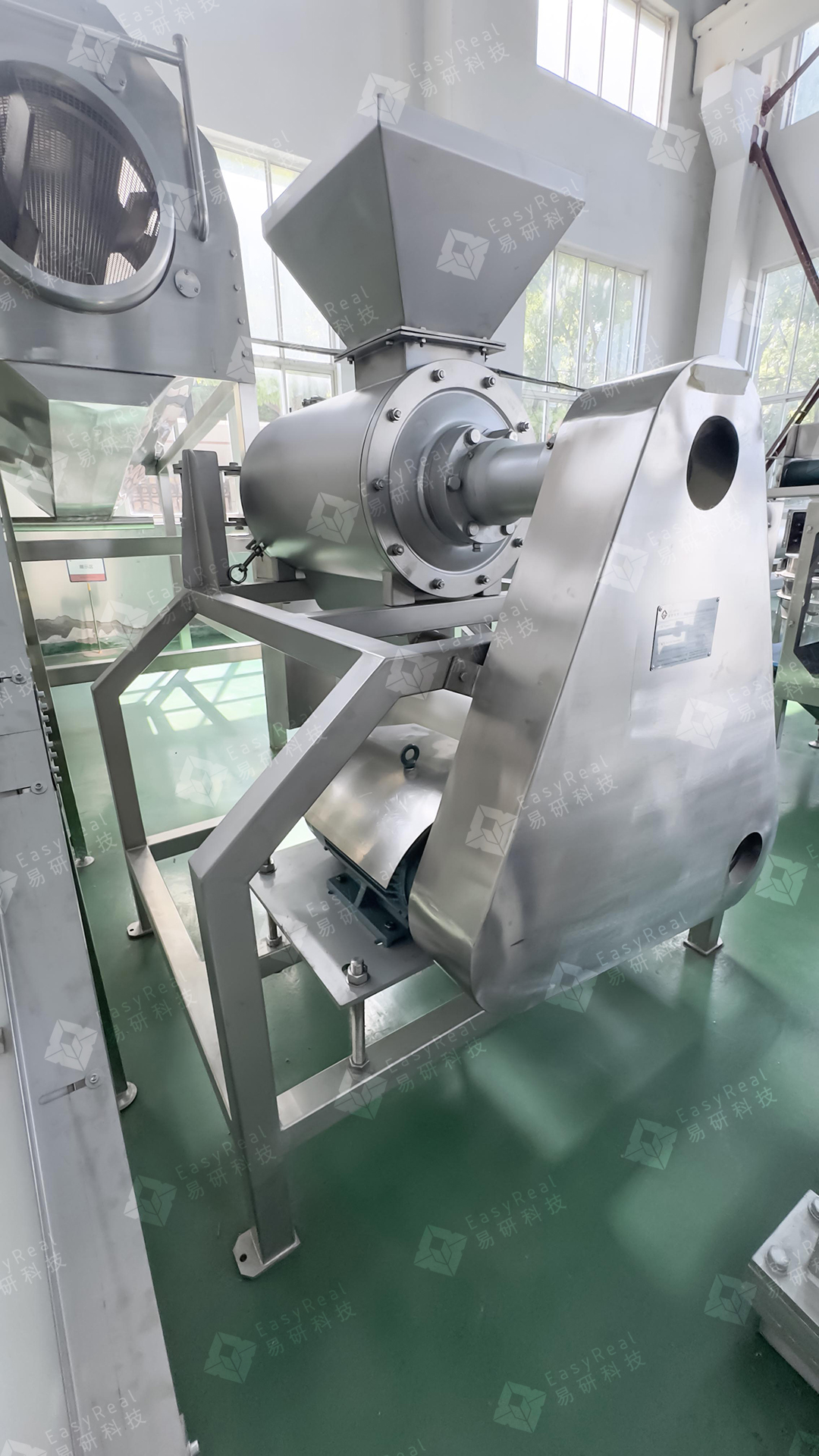 Actual stone-fruit destoner showing its feed hopper, separation chamber and guarded drive